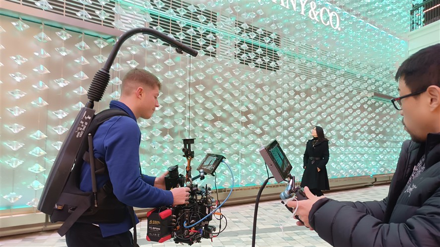 Retail-location production crew filming in a Beijing luxury store